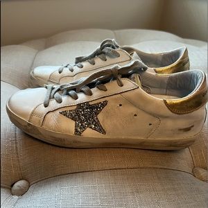 Golden Goose Superstar glitter star sneakers.
